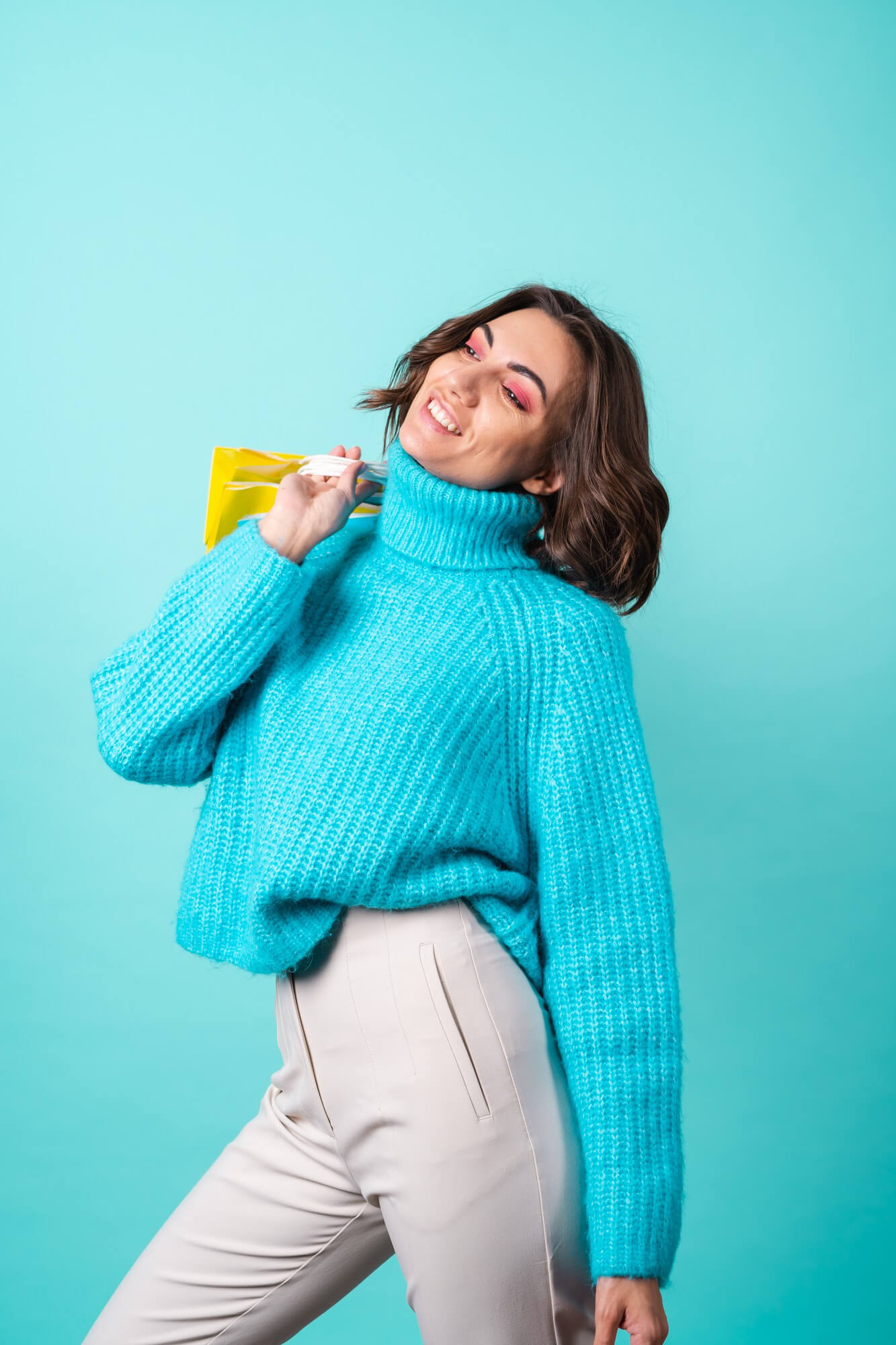 cozy-portrait-young-woman-knitted-blue-sweater-bright-pink-makeup-turquoise-holding-shopping-bags (1)